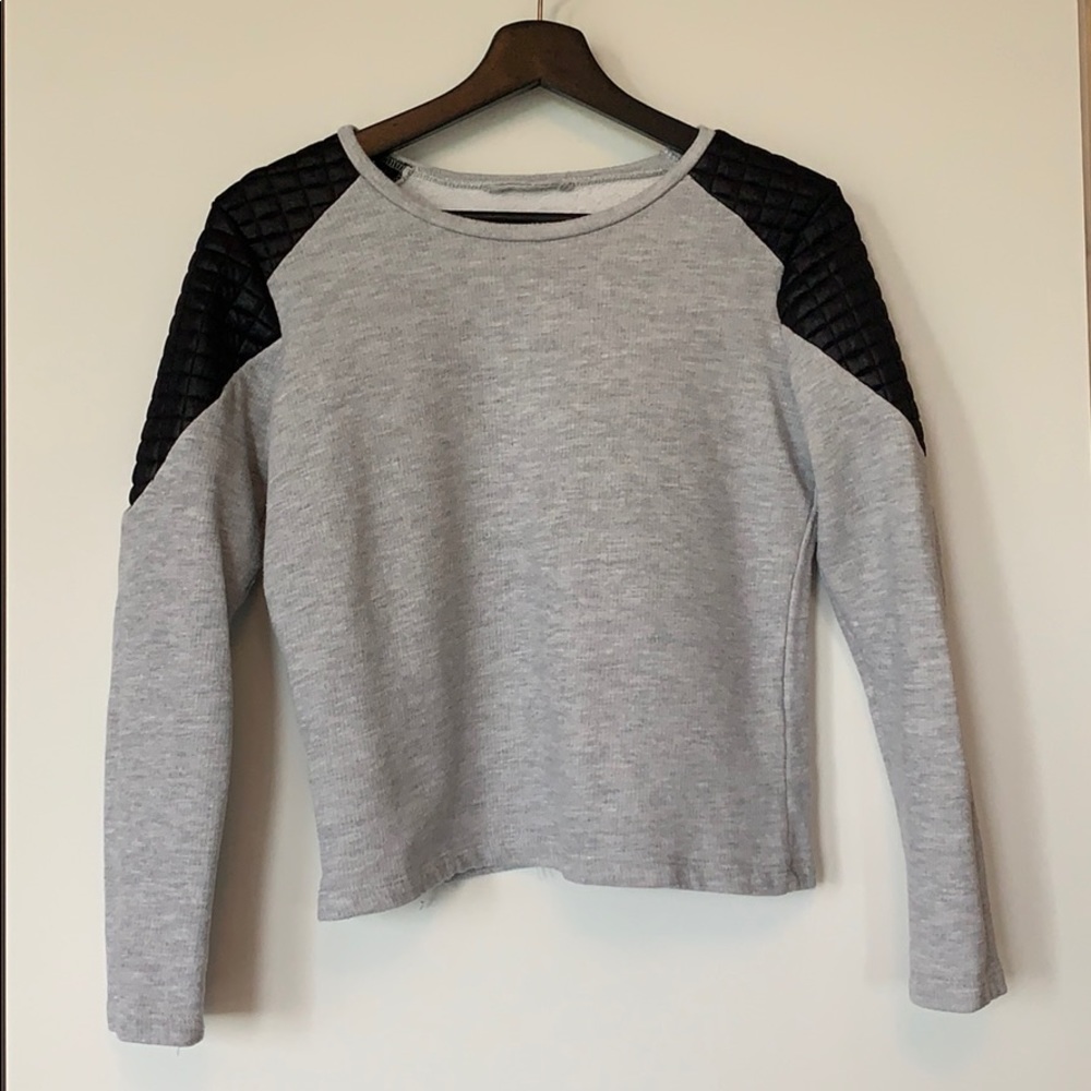 Grey sweater with black padded details